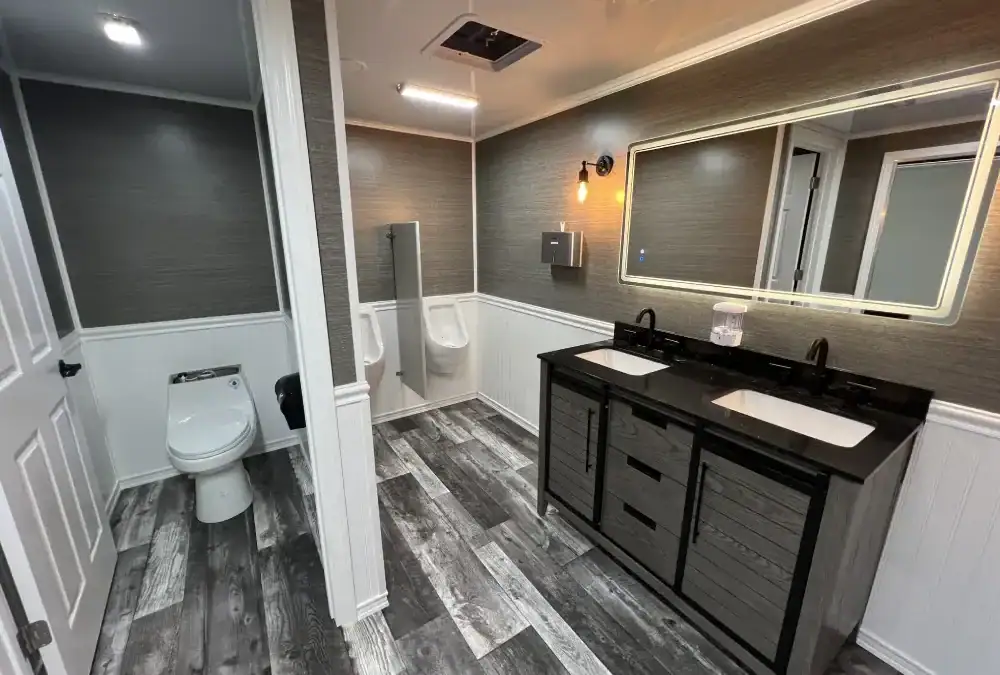 Modern luxury bathroom inside a Montondo trailer with dual sinks and stylish decor.